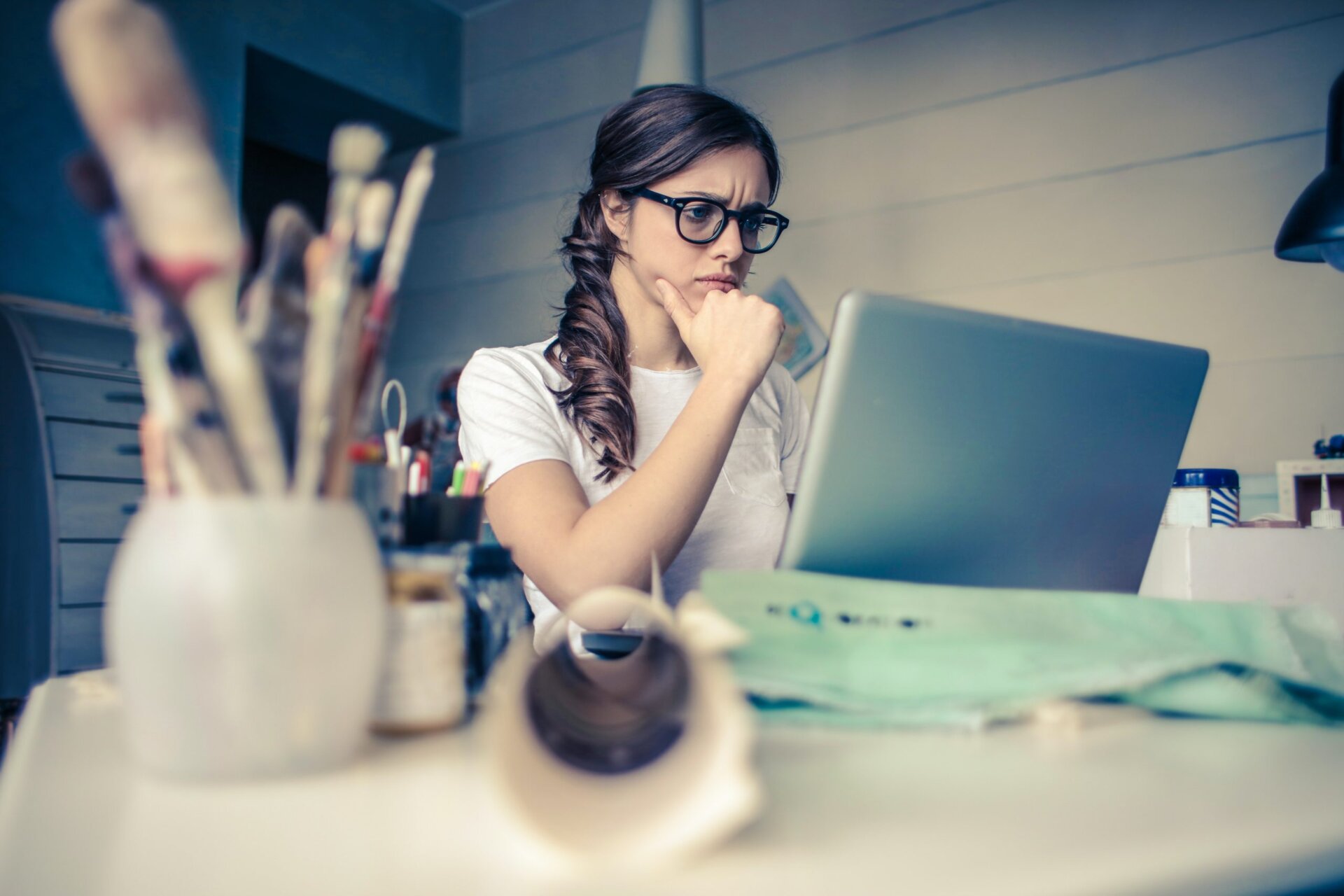 woman focused on laptop in studio