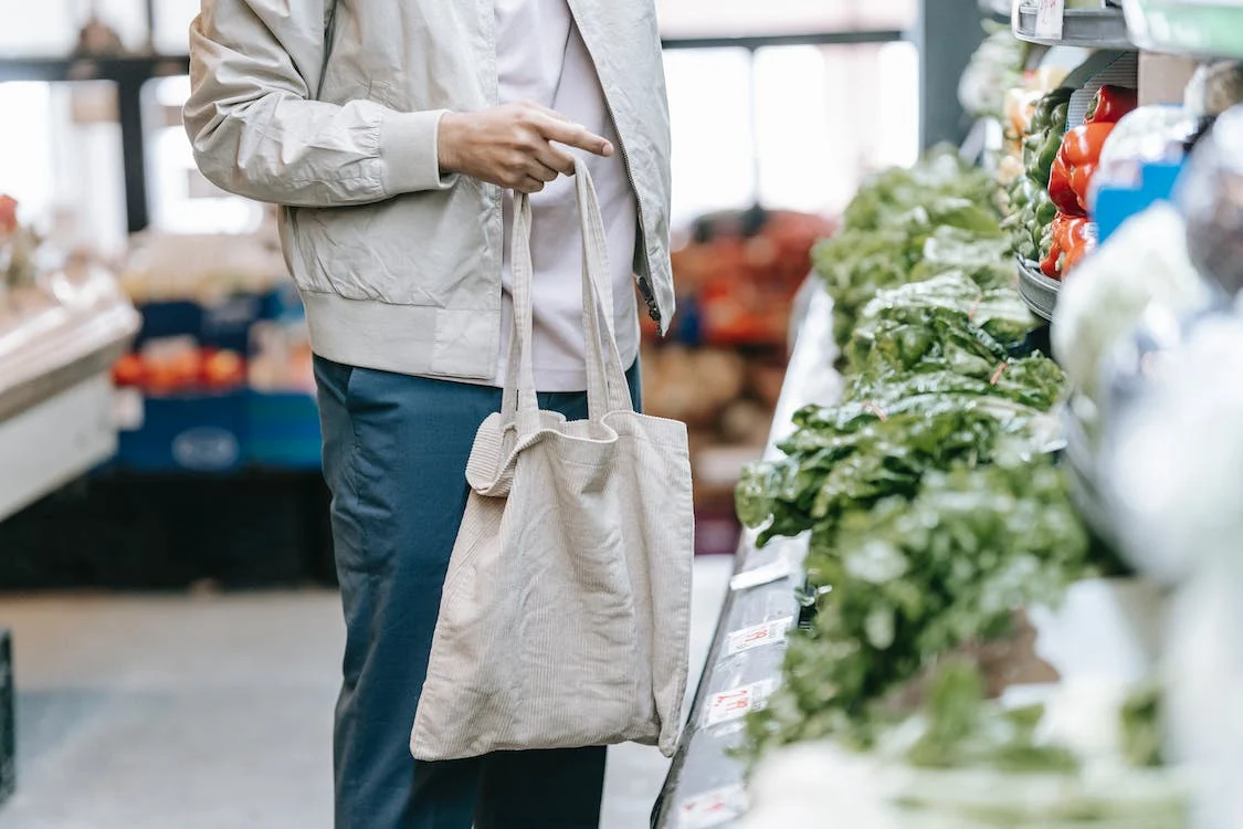 man looking at groceries in produce section