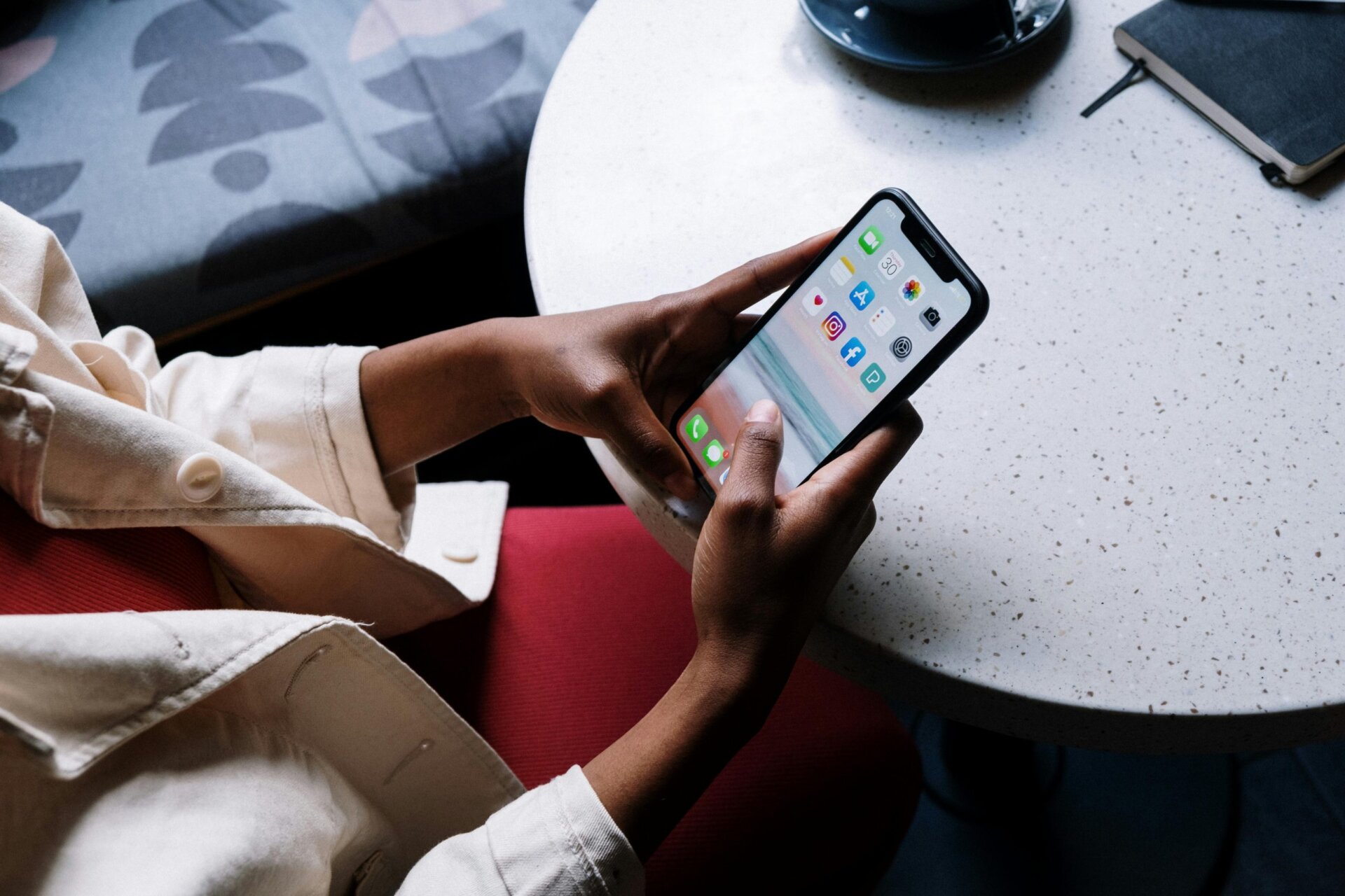 woman using cellphone at a table